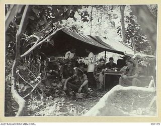 KARAWOP AREA, NEW GUINEA. 1945-04-20. 2/3 DENTAL UNIT TREATING MEMBERS OF 2/1 INFANTRY BATTALION. THIS IS THE FIRST TIME IN ANY CAMPAIGN THAT A DENTAL UNIT WAS UP WITH A FORWARD BATTALION WORKING ..
