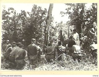 MOTUPINA POINT AREA, BOUGAINVILLE ISLAND. 1945-01-19. A ROMAN CATHOLIC PRIEST CELEBRATING MASS FOR THE TROOPS OF NO.5 BATTERY, 2ND FIELD REGIMENT, IN A JUNGLE SETTING
