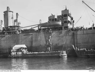 TOROKINA, BOUGAINVILLE. 1945-09-21. GENERAL VIEW OF JAPANESE TROOPS FROM NAURU ISLAND CLAMBERING DOWN THE SIDE OF THE SS RIVER BURDEKIN INTO BARGES WHICH WILL TAKE THEM ASHORE AT TOROKINA. THEY ..