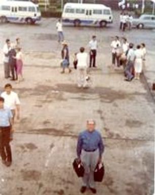 Claude Pepper holding travel bags