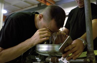 U.S. Air Force 36th Maintenance Squadron, 36th Air Expeditionary Wing TECH. SGT. Keith Parks flushes his eyes during a simulated contact with hydraulic fluid, while participating in exercise Beverly Bearcat at Andersen Air Force Base, Guam, on Dec. 3, 2004.(U.S. Air Force PHOTO by AIRMAN First Class Kristin Ruleau) (Released)