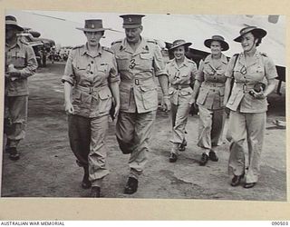 LAE, NEW GUINEA. 1945-03-26. LADY WAKEHURST (2), LADY BLAMEY (6), AND PARTY ON ARRIVAL AT THE AIRSTRIP ON A 2-DAY VISIT, WITH LORD WAKEHURST, GOVERNOR OF NEW SOUTH WALES, TO HEADQUARTERS FIRST ARMY ..