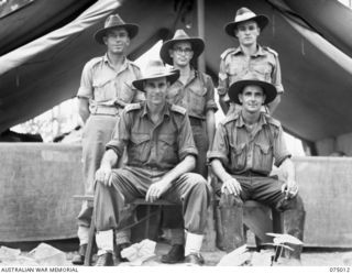 Members of the camp administration staff of Headquarters, 5th Division. Identified personnel are: (back row, standing, left to right) NX103799 Private (Pte) J A Halls,  QX50345 Pte G W Brennan, ..