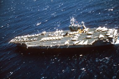 Aerial port view of the nuclear-powered aircraft carrier USS CARL VINSON (CVN 70) approaching Pearl Harbor, Hawaii
