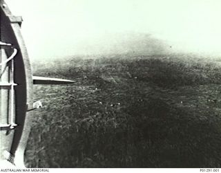 KOKODA, PAPUA, 1942-11-03. KOKODA AIRFIELD PHOTOGRAPHED FROM THE 5TH AIR FORCE (USAAF) C47 TRANSPORT AIRCRAFT "IRENE" THE MORNING AFTER KOKODA WAS RE-CAPTURED. "IRENE" FLOWN BY SERGEANT FORDE ..