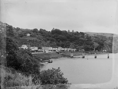 [Pacific Island waterfront with buildings and jetty]