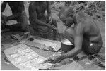 Kwaa'ala putting the coconut cream on the dough