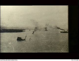 Lae, New Guinea. c. 1943. Vessels in a Japanese convoy on fire and sinking after strafing by Beaufighter aircraft of No. 30 Squadron RAAF. (Donor F. Cassidy)