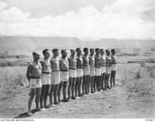 KELANOA, NEW GUINEA, 1944-02-21. MEMBERS OF THE 2/14TH FIELD REGIMENT, 8TH DIVISION (THEIR COLOUR PATCH IS BROKEN IN HALF TO DENOTE THE BROKEN 8TH), ARE THE WINNING TEAM OF COMBINED BEACH SPORTS ..