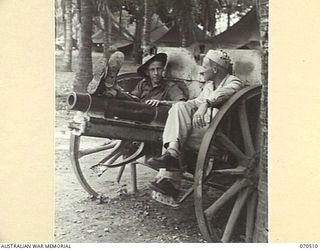 PORT MORESBY, PAPUA, 1944-02. DRIVER NORRIS J. COSSINS, NEW GUINEA FORCE PUBLIC RELATIONS FIELD UNIT (1), AND PRIVATE FIRST CLASS CLAY H. ALLEN OF OZERK, MISSOURI TALK THINGS OVER WHILE RECLINING ..