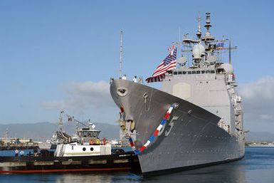 A port bow view showing the US Navy (USN) Ticonderoga Class; Guided Missile Cruiser (Aegis), USS CHOSIN (CG 65), being assisted by a commercial tugboat, while conducting mooring operations at Naval Base (NB) Pearl Harbor, Hawaii (HI), after returning from six-month deployment in support the global war on terrorism