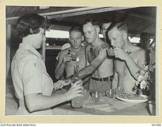 TOROKINA, BOUGAINVILLE. 1945-04-19. MISS O. BANKS (1), SERVING SOFT DRINKS, ONE OF THE MANY SERVICES GIVEN BY THE RED CROSS AT THE 2/1 GENERAL HOSPITAL