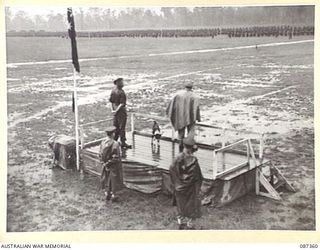 HERBERTON, QUEENSLAND. 1945-03-03. MAJOR GENERAL G.F. WOOTTEN, GENERAL OFFICER COMMANDING 9 DIVISION, (1), AT HEADQUARTERS 24 INFANTRY BRIGADE ADDRESSING A PARADE HELD ON THE RACECOURSE DURING THE ..