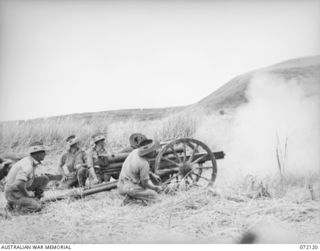 FORTIFICATION POINT, NEW GUINEA. 1944-04-06. A JAPANESE 75MM REGIMENTAL GUN TYPE MEIJI 41 BEING FIRED WITH A LANYARD BY MEMBERS OF THE 2/14TH FIELD REGIMENT AT THE FRONTAL ARMOUR OF A DISABLED ..