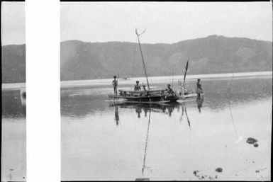 Group of people standing in and around two outrigger canoes, Papua, ca. 1923 / Sarah Chinnery