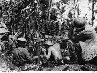 1943-01-27. PAPUA. SANANANDA AREA. PREPARING THE WAY FOR A FURTHER ADVANCE AT SANANANDA. AUSTRALIAN MORTARS LAYING A BARRAGE. IT IS CLAIMED THAT WELL TRAINED AUSTRALIAN MORTAR CREWS IN PAPUA CAN ..