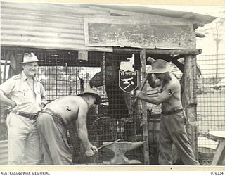 LAE, NEW GUINEA. 1944-09-28. THE BLACKSMITH SHOP, 22ND WORKS COMPANY, ROYAL AUSTRALIAN ENGINEERS. IDENTIFIED PERSONNEL ARE:- N104196 LIEUTENANT J.R. SMITH, CAMP MAINTENANCE OFFICER (1); N453494 ..