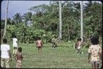 Soccer (football) players in action, ball in the air