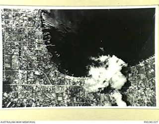 RABAUL, 1944-10. VIEW OF HARBOUR AND TOWN SHOWS COMPLETE ABSENCE OF SHIPPING AND LITTLE LEFT STANDING IN TOWN. (DONOR: W. TUCK)