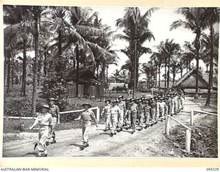 PALMALMAL PLANTATION, JACQUINOT BAY, NEW BRITAIN, 1945-08-19. MALE MEMBERS OF THE STAFF OF 2/8 GENERAL HOSPITAL MARCHING THROUGH HOSPITAL GROUNDS TO THE CHAPEL TO ATTEND A THANKSGIVING SERVICE ..