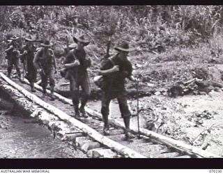 FARIA VALLEY, NEW GUINEA. 1944-02-10. PERSONNEL OF D COMPANY, 2/10TH INFANTRY BATTALION CROSSING THE FARIA RIVER ON THEIR JOURNEY TO THE RAMU VALLEY AFTER BEING RELIEVED FROM FORWARD POSITIONS IN ..