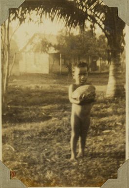 Child holding a coconut, 1928