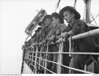 AT SEA, NEW GUINEA. 1944-10-06. MEMBERS OF THE 36TH INFANTRY BATTALION LINING THE RAIL OF THE DUTCH TROOPSHIP, "SWARTENHONDT" ENROUTE FROM NEW GUINEA.GUINEA TO NEW GUINEA.BRITAIN. IDENTIFIED ..