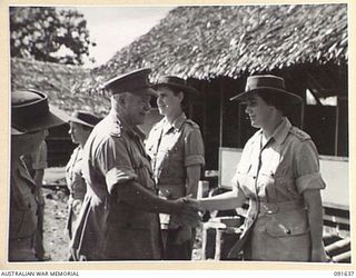 LAE, NEW GUINEA. 1945-05-11. GENERAL SIR THOMAS A. BLAMEY, COMMANDER-IN-CHIEF, ALLIED LAND FORCES, SOUTH WEST PACIFIC AREA (3), SHAKING HANDS WITH LIEUTENANT J.I. HENNESSY (5), DURING AN INSPECTION ..
