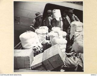 WEWAK AIRSTRIP, NEW GUINEA. 1945-08-06. KAI BOMBERS BEING LOADED BY HEADQUARTERS COMMAND, AUSTRALIAN ARMY SERVICE CORPS, 6 DIVISION. UNITS IN REMOTE FORWARD AREAS ARE SUPPLIED BY PARACHUTE DROPS ..