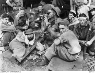 NADZAB, NEW GUINEA. 1943-09-20. WOUNDED MEMBERS OF THE 2/6TH AUSTRALIAN INDEPENDENT COMPANY WITH THEIR SOUVENIRS AT THE STRIP EVACUATION POINT. SHOWN: VX62448 TROOPER (TPR) D. E. PULLYN (2); ..