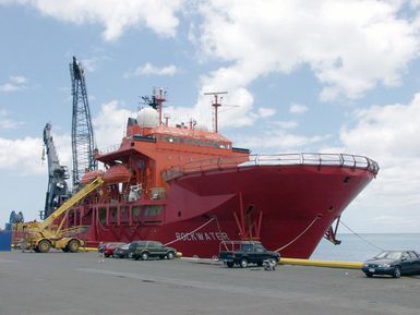 A starboard bow view of the Bahamian, Multi-purpose Diving Support Vessel (DSV) "Rockwater 2"moored to the pier at Pearl Harbor, Hawaii (HI), as equipment and supplies are loaded, in preparation for the Ehime Maru recovery operations