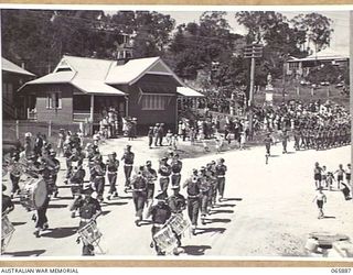 HERBERTON, QLD. 1944-04-25. THE BAND OF THE 2/2ND INFANTRY BATTALION FOLLOWED BY TROOPS OF THE 6TH DIVISION, LEADING THE MARCH BACK TO THE DISPERSAL AREA AT THE SHIRE HALL, AT THE CONCLUSION OF THE ..