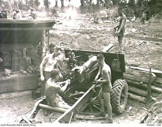 THE SOLOMON ISLANDS, 1945-04-24/27. AUSTRALIAN ARTILLERYMEN ON BOUGAINVILLE ISLAND SERVICING THEIR 25 POUND GUN. (RNZAF OFFICIAL PHOTOGRAPH.)