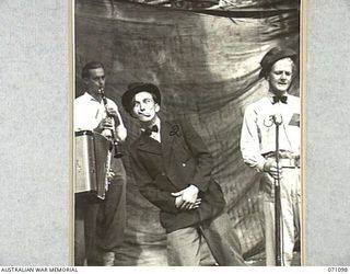 KILIGIA, NEW GUINEA. 1944-03-13. MEMBERS OF THE 3RD ARMOURED DIVISION CONCERT PARTY REHEARSING FOR "SHELLSAPOPPIN", A SHOW WELL KNOWN TO TROOPS IN NEW GUINEA. THE CONCERT PARTY IS AT PRESENT ..