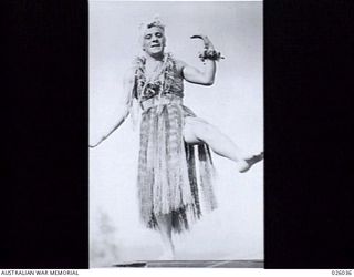 PAPUA, NEW GUINEA, 1942-07. PRIVATE LES HOMSEY WHO FEATURES IN THE BALLET PRESENTED BY THE PORT MORESBY CONCERT PARTY AND FIRES THE IMAGINATION OF HIS AUDIENCE OF AUSTRALIAN AND AMERICAN TROOPS ..