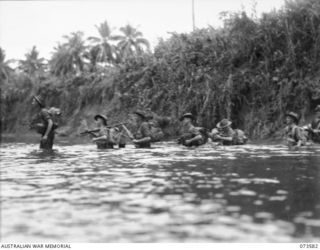 SARANG RIVER, NEW GUINEA. 1944-05-26. TROOPS OF THE 35TH INFANTRY BATTALION CROSS THE RIVER DURING THEIR DRIVE UP THE COAST TOWARDS WEWAK. IDENTIFIED PERSONNEL ARE:- NX192079 PRIVATE R. BULL (1); ..