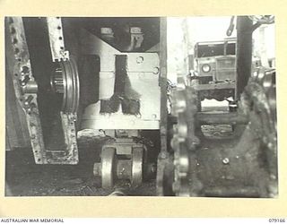 TOROKINA, BOUGAINVILLE ISLAND. 1945-02-21. A DRIVING SPROCKET REMOVED FROM A "MATILDA" TANK OF B SQUADRON, 2/4TH ARMOURED REGIMENT SHOWING THE EFFECTIVENESS OF A NEW SPROCKET SCRAPER NOW FITTED. ..