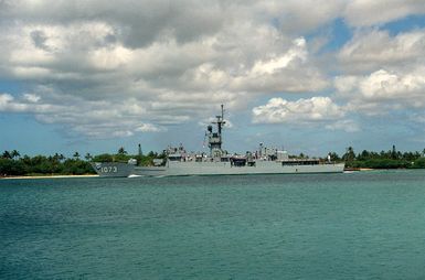 The frigate USS ROBERT E. PEARY (FF-1073) steams through the channel as it heads out to sea after a visit to the naval station.