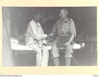 MADANG, NEW GUINEA. 1944-07-27. LIEUTENANT COLONEL, THE HONOURABLE E.T.R. WICKHAM, MVO, MEMBER FOR TAUNTON IN THE BRITISH HOUSE OF COMMONS, LEADER (1) CHATTING WITH SUBADAH MAJOR BABU RAM, 1/14TH ..