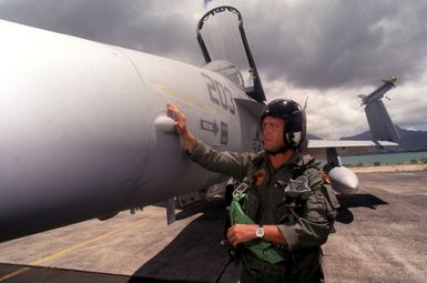 MAJ Dwight Schmidt, assigned to VMFA-142 based at Atlanta, Georgia, pre-flights his F/A-18 Hornet before his mission during exercise RIMPAC '98