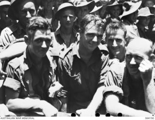 TOWNSVILLE, QLD. 1944-01-28. PERSONNEL OF HEADQUARTERS COMPANY 2/28TH INFANTRY BATTALION ABOARD THE TROOPSHIP "VAN HEUTSZ" IMPATIENTLY WAITING TO LAND IN AUSTRALIA ON RETURN HOME AFTER A LONG TOUR ..