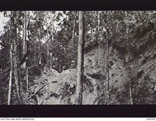 BULLDOG ROAD, NEW GUINEA, 1943-07-17. SIDES OF CUTTING WHICH HAVE FORMED INTO A LANDSLIDE AT BANNON'S LOOKOUT