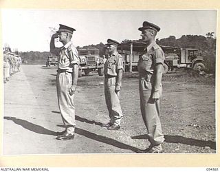LAE AREA, NEW GUINEA, 1945-08-05. BRIGADIER P.S. MCGRATH, DEPUTY DIRECTOR OF SUPPLIES AND TRANSPORT (1), TAKING THE SALUTE DURING THE MARCH PAST OF 151 GENERAL TRANSPORT COMPANY. IDENTIFIED ..