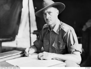 POTSDAM, NEW GUINEA. 1944-09-05. SX3709 LIEUTENANT-COLONEL J.G. MCKINNA, COMMANDING OFFICER, 25TH INFANTRY BATTALION AT WORK IN HIS OFFICE