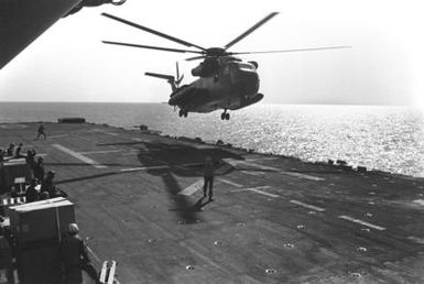 A CH-53 Sea Stallion helicopter lands aboard the amphibious assault ship USS GUAM (LPH 9), as the 22nd Marine Amphibious Unit redeploys from Beirut at the conclusion of a multinational peacekeeping operation