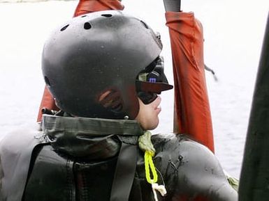 A Navy SEAL participating in Exercise DYNAMIC MIX is pulled from the water onboard a USS SAIPAN (LHA 2) helicopter off the coast of Capo Teulada, Sardinia