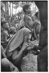 Bride price for Mitsi: woman from the bride's group is fed pork provided by the groom's group