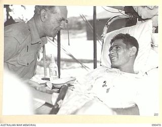 TOROKINA, BOUGAINVILLE. 1945-04-11. SENATOR J.M. FRASER, ACTING MINISTER FOR THE ARMY (1), TALKING TO PRIVATE F. TRIPPITT (2), DURING HIS VISIT TO 2/1 GENERAL HOSPITAL