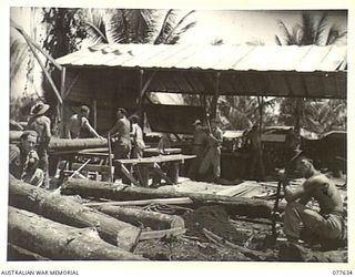 JACQUINOT BAY, NEW BRITAIN. 1944-12-18-20. PERSONNEL OF THE 55TH FIELD PARK COMPANY, WORKING IN THE UNIT SAWMILL. IDENTIFIED PERSONNEL ARE:- QX59488 CORPORAL J. LLEWELLYN (1); QX33994 SAPPER P. ..