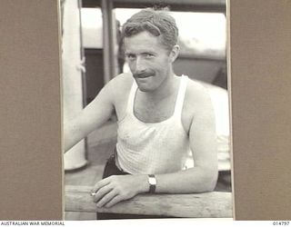 1943-05-07. NEW GUINEA. MILNE BAY. AN ALLIED VESSEL WAS HIT DURING THE 1943-04-14. JAPANESE RAID ON MILNE BAY. PICTURE SHOWS L. GOUGH OF LONDON, WHO WAS CREDITED WITH THE SHOOTING DOWN OF A JAP ..